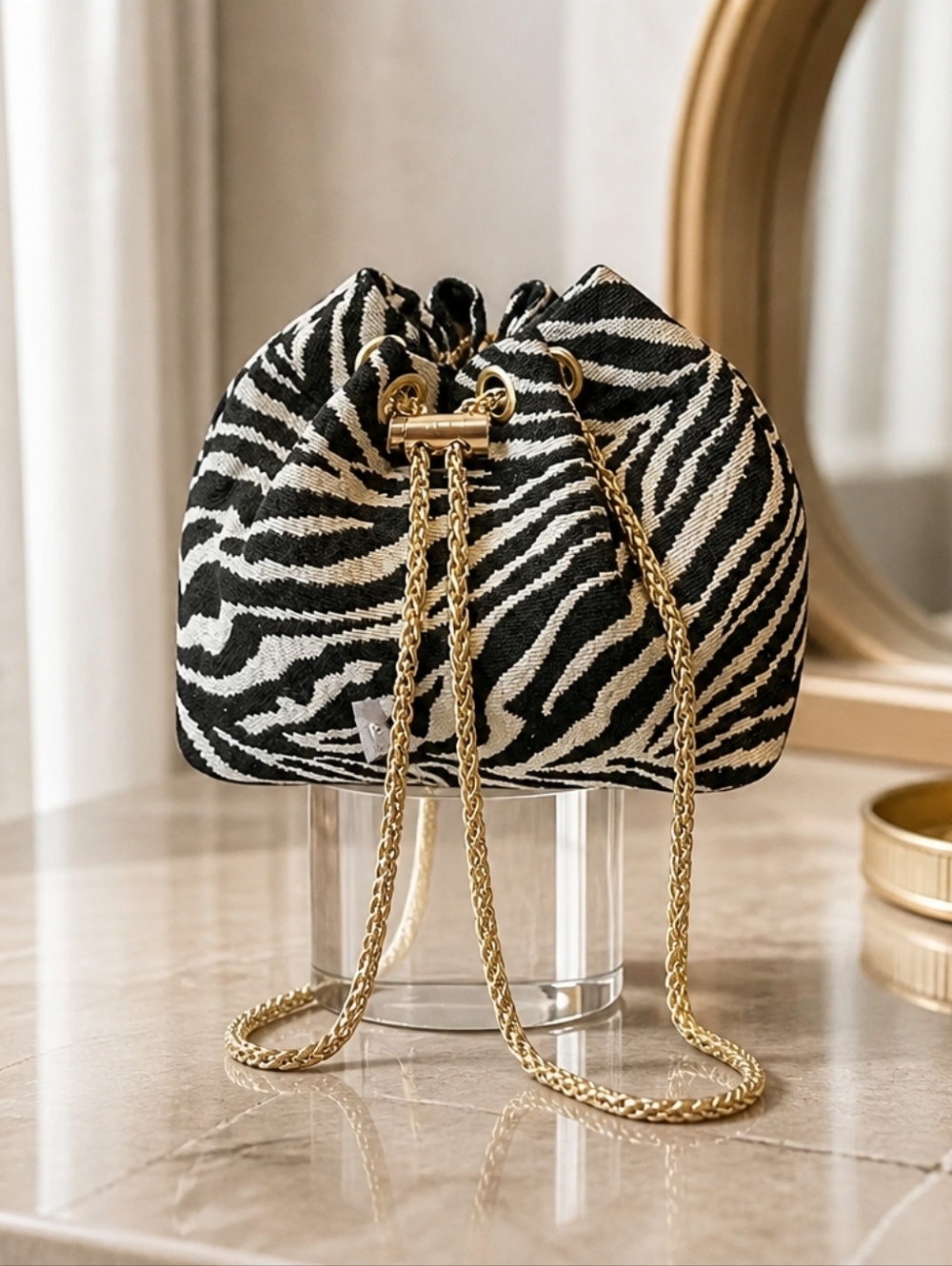 Zebra Print Drawstring Bucket Bag with Gold Chain Strap